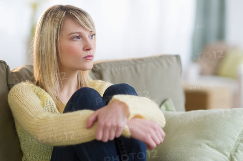 Woman sitting on sofa.