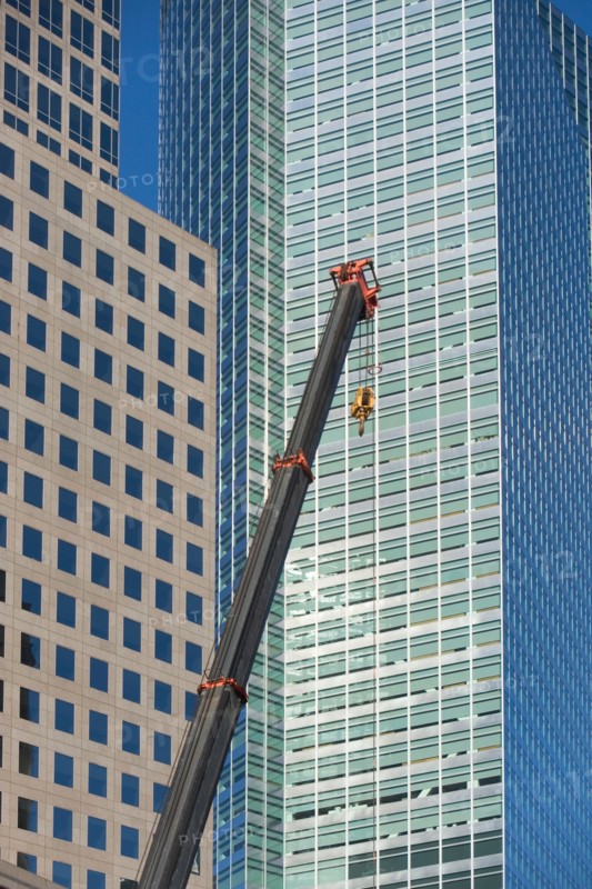 Usa, New York State, New York City, crane's hook in front of skyscraper. Photo : fotog