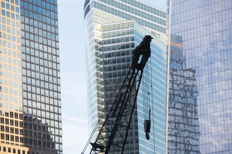 Usa, New York State, New York City, crane's hook in front of skyscraper. Photo : fotog