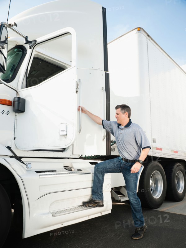 Truck driver entering truck.