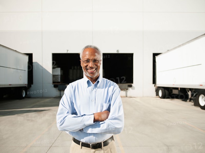 Portrait of businessman outside warehouse.