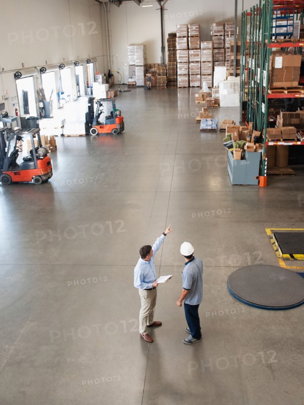 Workers talking in warehouse.