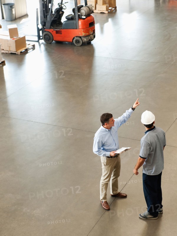 Workers talking in warehouse.