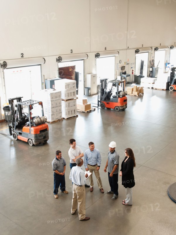 Workers talking in warehouse.