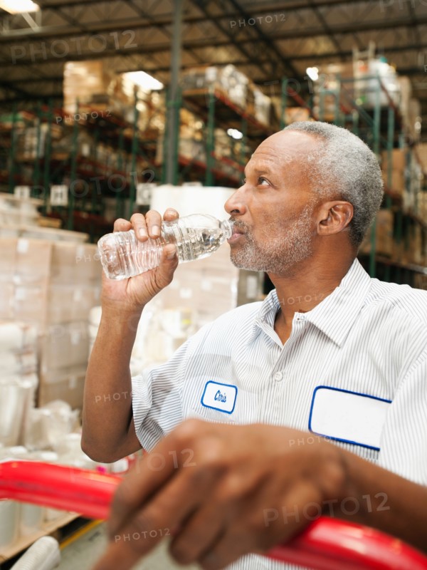 Warehouse worker drinking water.