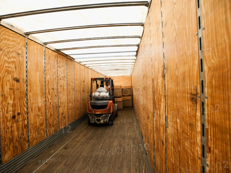 Forklift truck inside trailer.