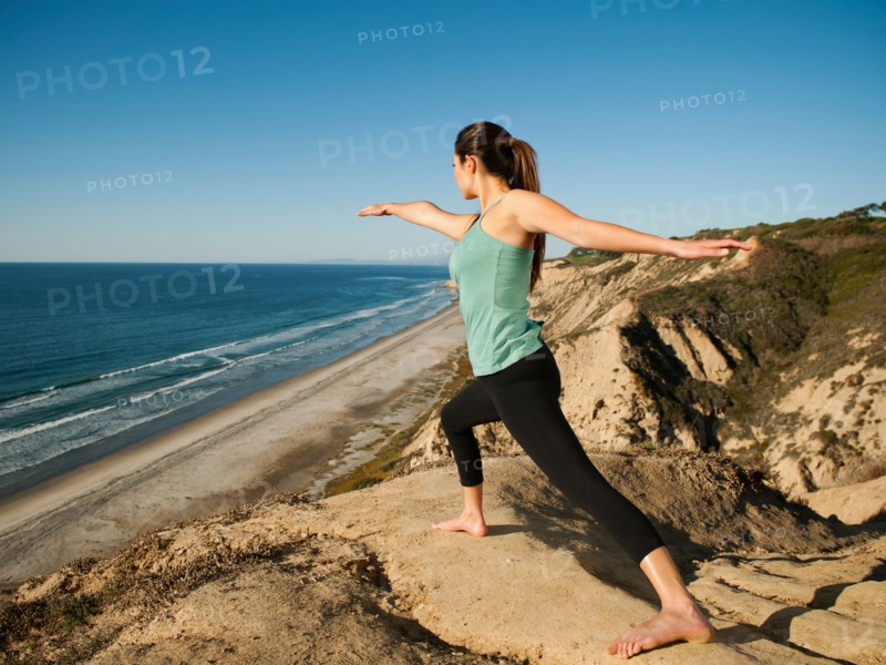 USA, California, San Diego, Woman practicing yoga on beach.
