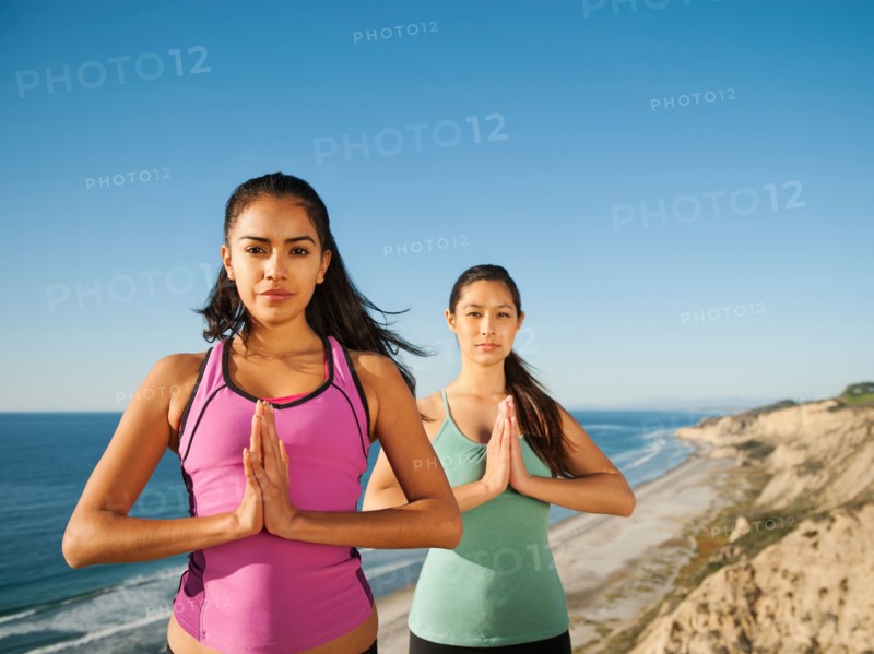 USA, California, San Diego, Two women practicing yoga on beach.