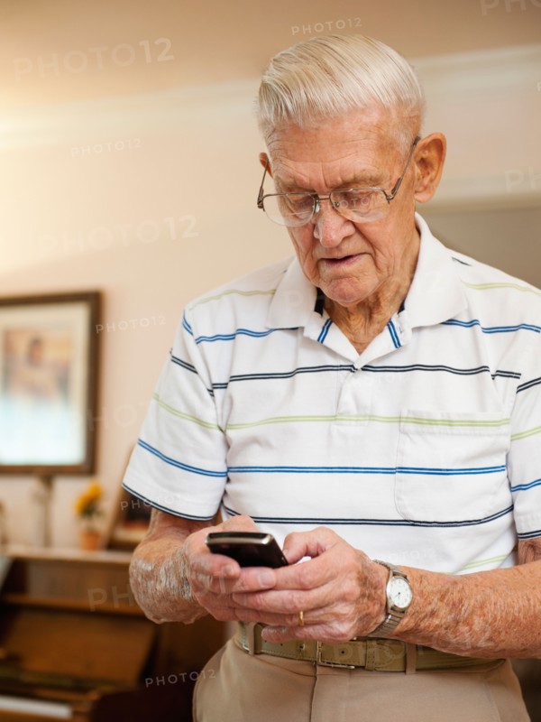 Senior man using phone.
