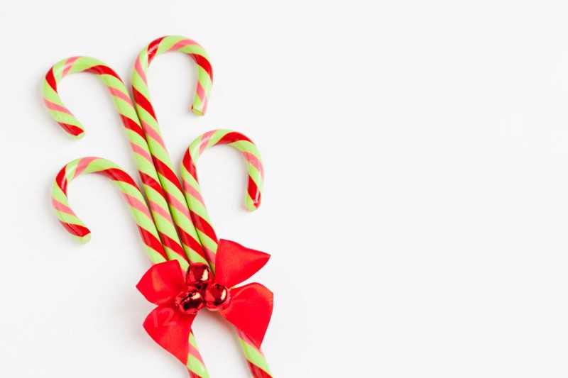 Striped candy canes with red ribbon, studio shot. Photo : Sarah M. Golonka
