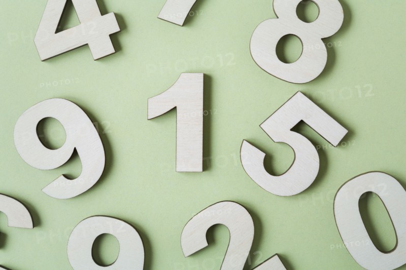 Numbers on white background, studio shot. Photo : Kristin Lee