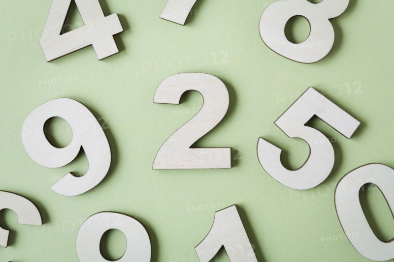 Numbers on white background, studio shot. Photo : Kristin Lee