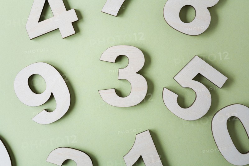 Numbers on white background, studio shot. Photo : Kristin Lee