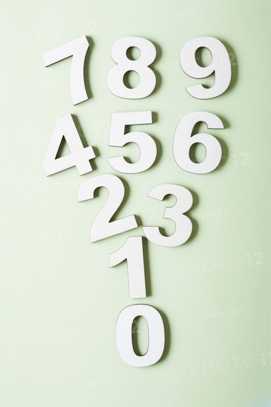 Numbers on white background, studio shot. Photo : Kristin Lee
