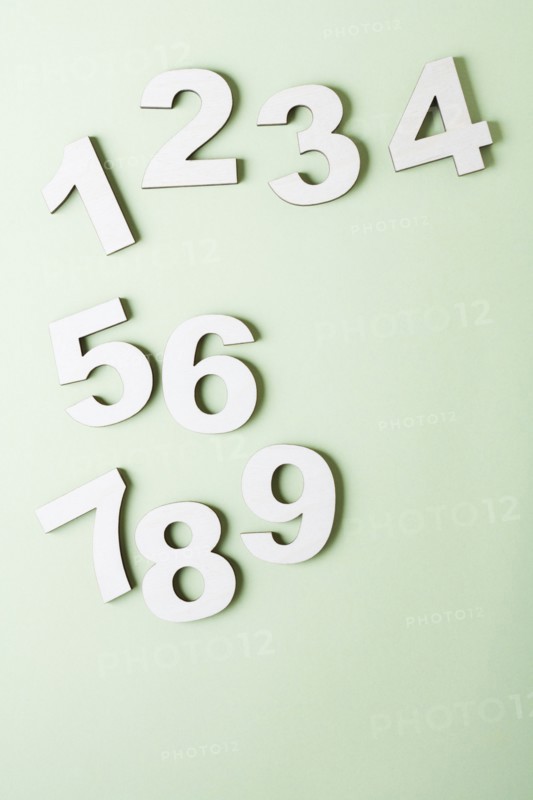 Numbers on white background, studio shot. Photo : Kristin Lee