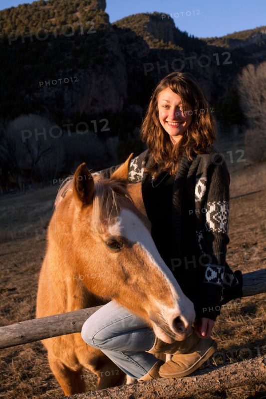 Portrait of young smiling woman with horse. Photo : John Kelly
