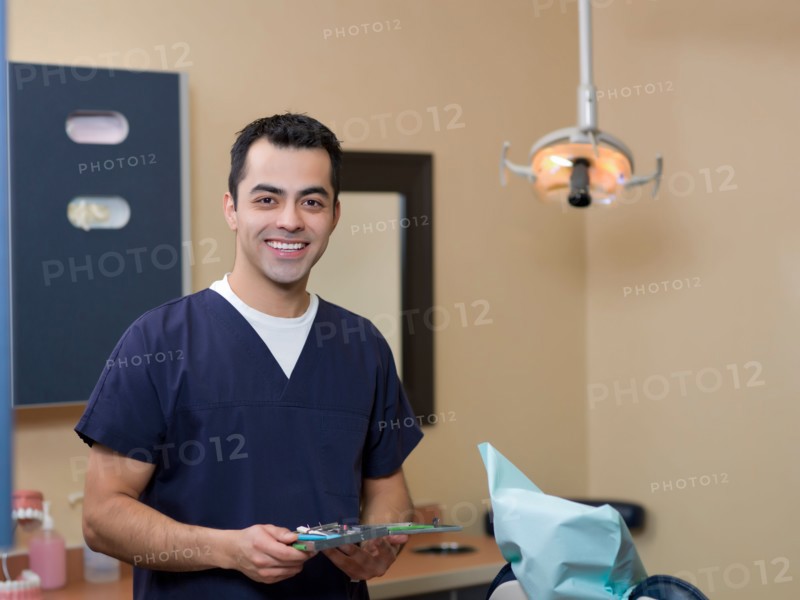 Portrait of smiling dentist in surgery. Photo : Dan Bannister