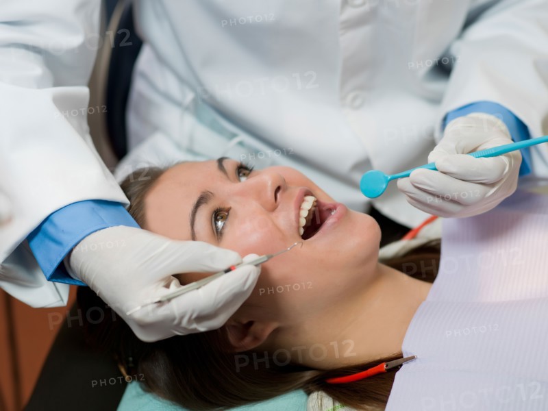 Dentist and patient in dental surgery. Photo : Dan Bannister