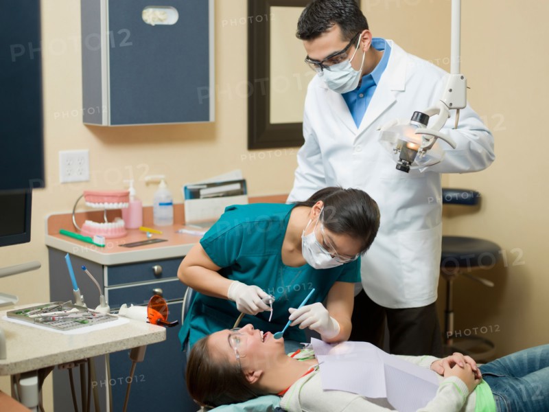 Dentists and patient in dental surgery. Photo : Dan Bannister