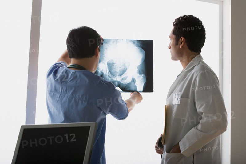 Two doctors looking at x-ray image. Photo : Rob Lewine
