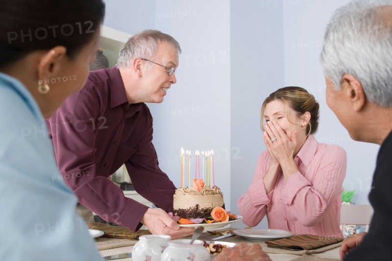 Friends celebrating mature women's birthday. Photo : Rob Lewine