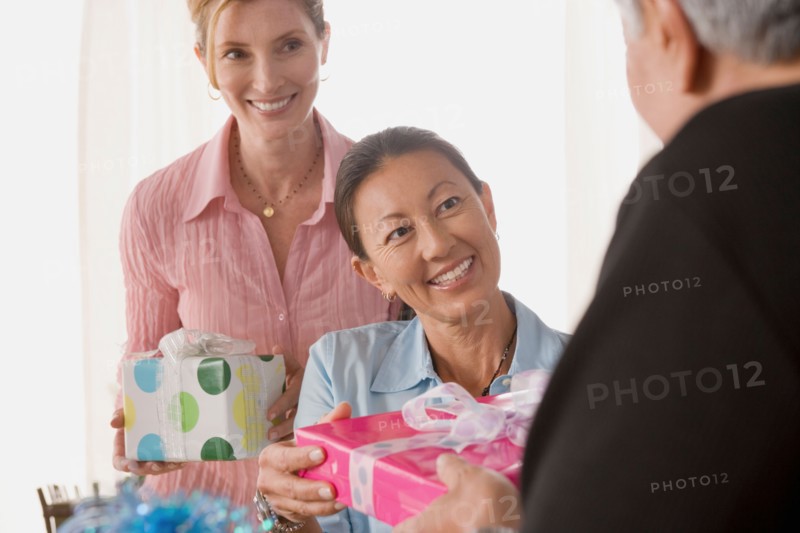 Friends celebrating mature women's birthday. Photo : Rob Lewine