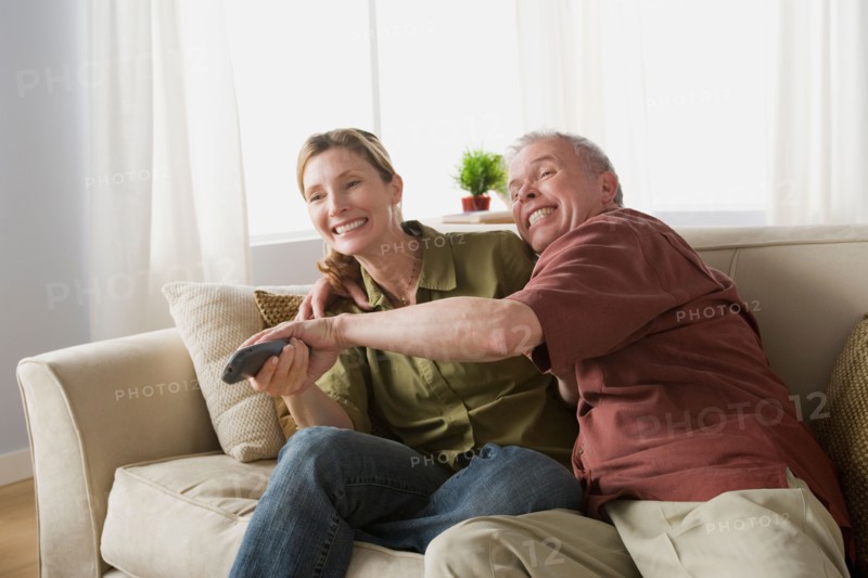 Couple fighting for tv remote. Photo : Rob Lewine