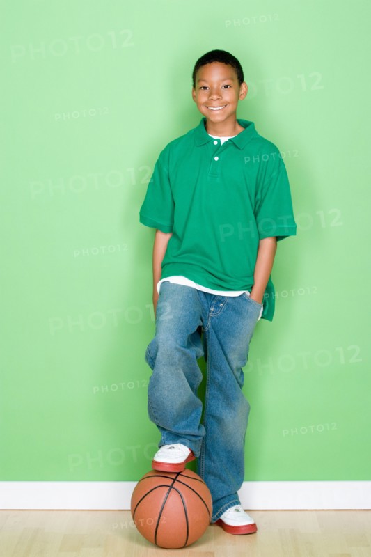 Studio portrait of teenage boy with basketball. Photo : Rob Lewine