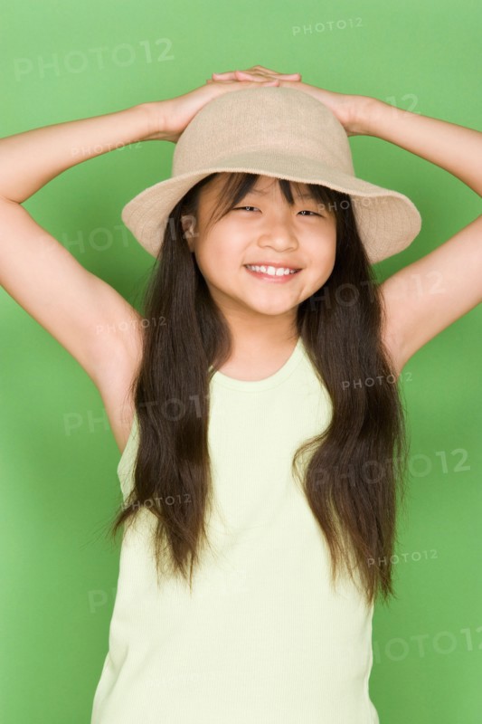 Studio shot portrait of teenage girl with hat, waist up. Photo : Rob Lewine
