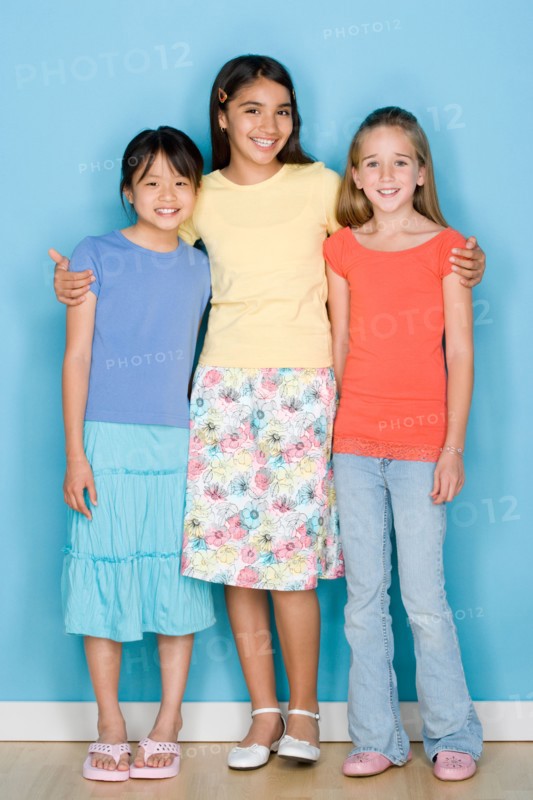 Studio shot portrait of three teenage girls, full length. Photo : Rob Lewine