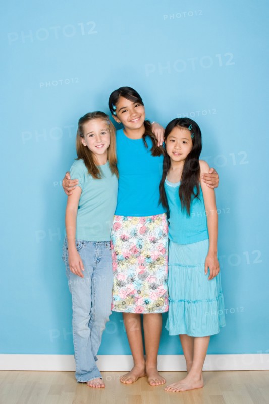 Studio shot portrait of three teenage girls, full length. Photo : Rob Lewine