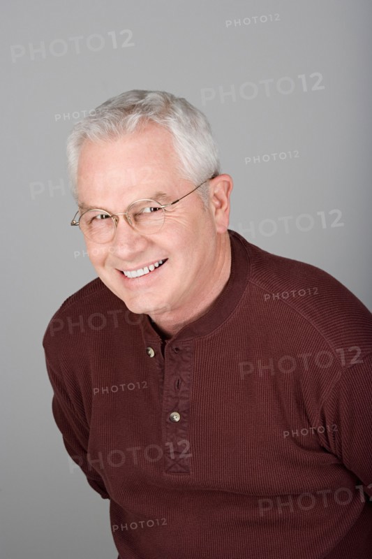 Studio shot portrait of smiling senior man, head and shoulders. Photo : Rob Lewine