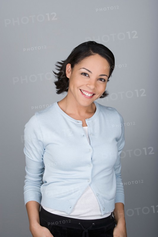 Studio shot portrait of smiling mid adult woman, waist up. Photo : Rob Lewine