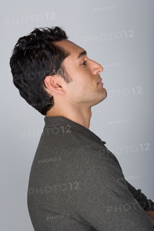 Side view of mid adult man with hands on hip, head and shoulders. Photo : Rob Lewine