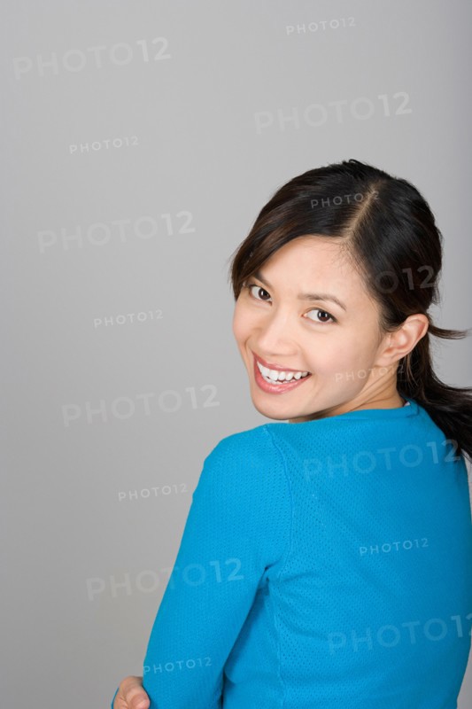 Studio portrait of happy Vietnamese woman. Photo : Rob Lewine