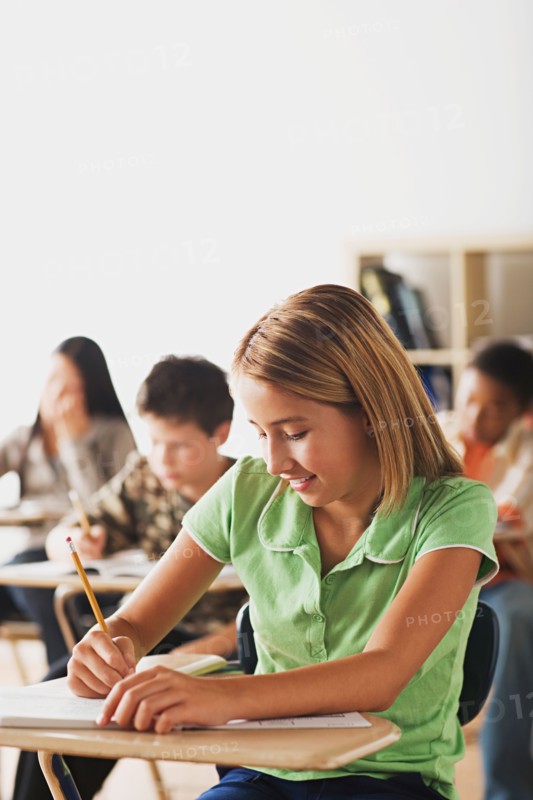 School kid writing in their copybooks. Photo : Rob Lewine