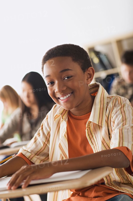 Schoolboy sitting in classroom. Photo : Rob Lewine