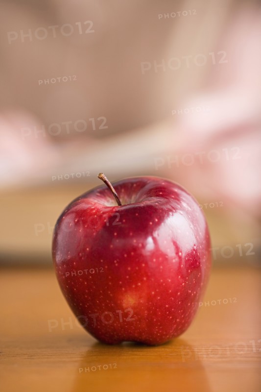 Red apple on desk. Photo : Rob Lewine