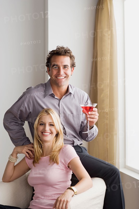 Portrait of smiling couple at home party. Photo : Rob Lewine