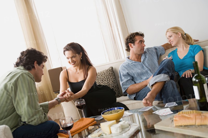 Couples on sofa at home party. Photo : Rob Lewine