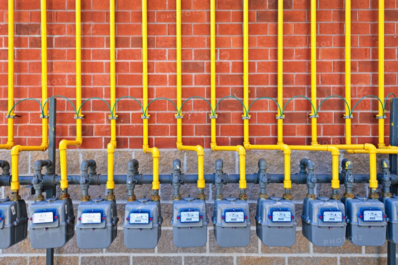 Gas meters against brick wall. Photo :  Elena Elisseeva