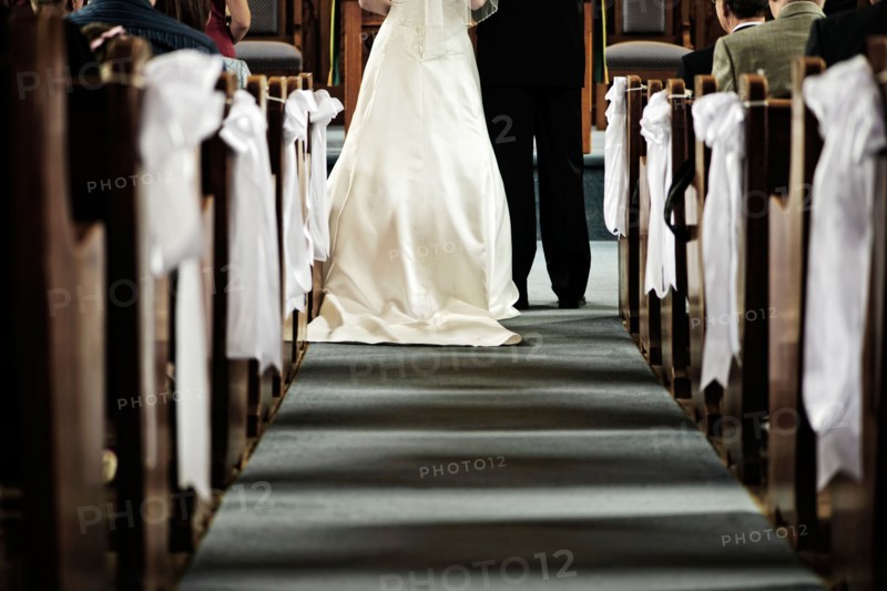 Low section of bride and groom in church. Photo :  Elena Elisseeva