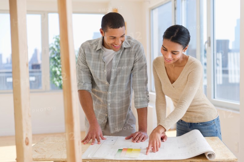 Couple looking at house blueprints.