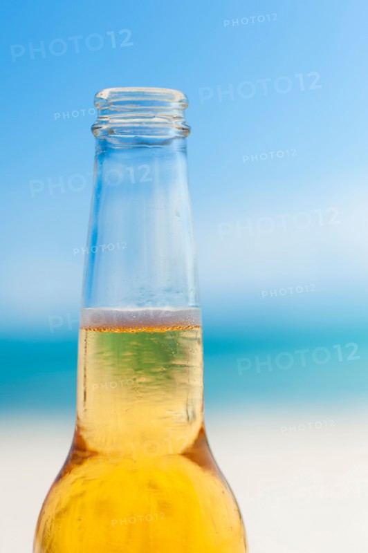 Beer bottle on beach.