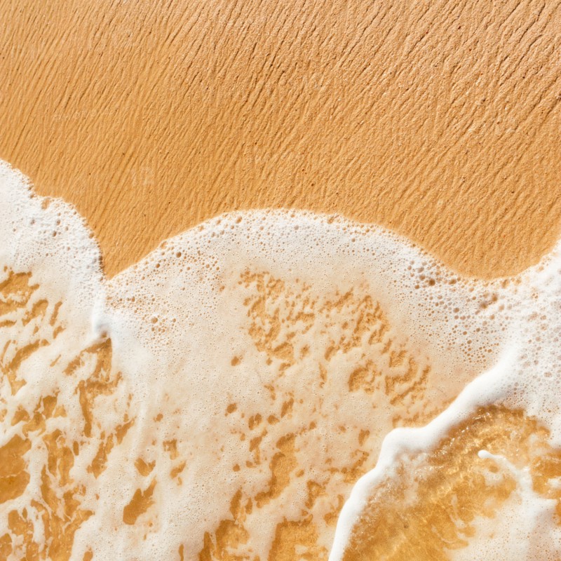 Mexico, Yucatan. Sea waves on beach sand.