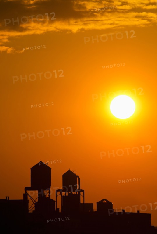 Silhouette of water tower at sunset.
