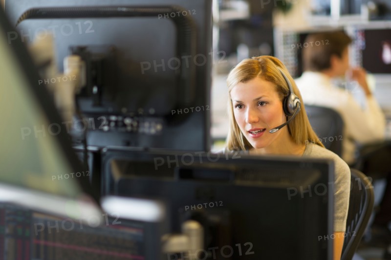 Female trader at trading desk.