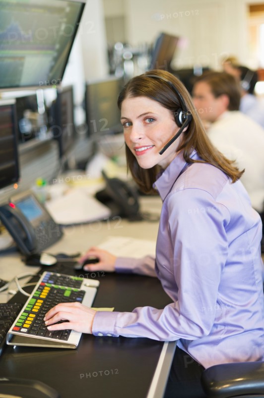 Portrait of female trader at trading desk.