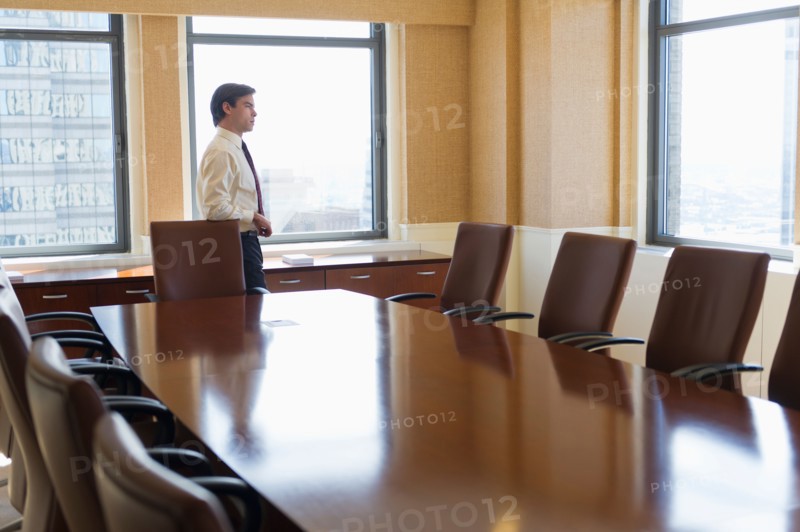Businessman standing in board room.
