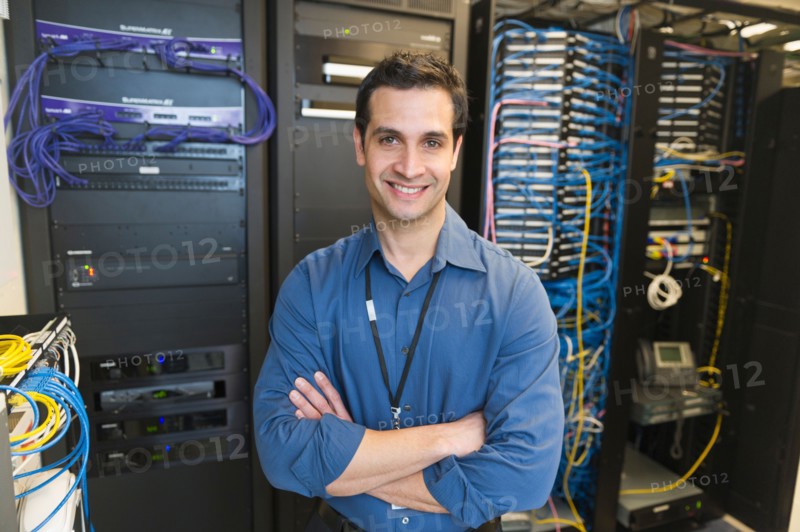 Portrait of technician in network server room.